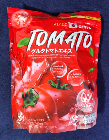 Red package of MIKAO tomato extract on a dark blue background