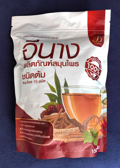 Tea package with a glass of tea and tea leaves on a blue background